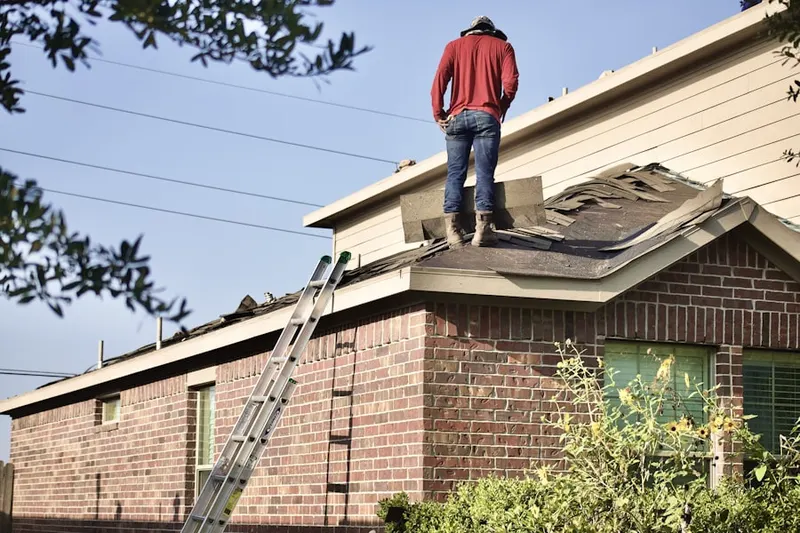 Professional roofer working on a residential roof in John's Creek Walk